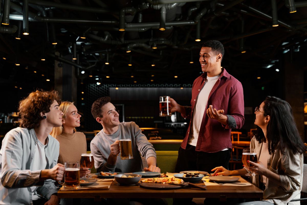 Friends raising a toast over dinner and drinks at a restaurant